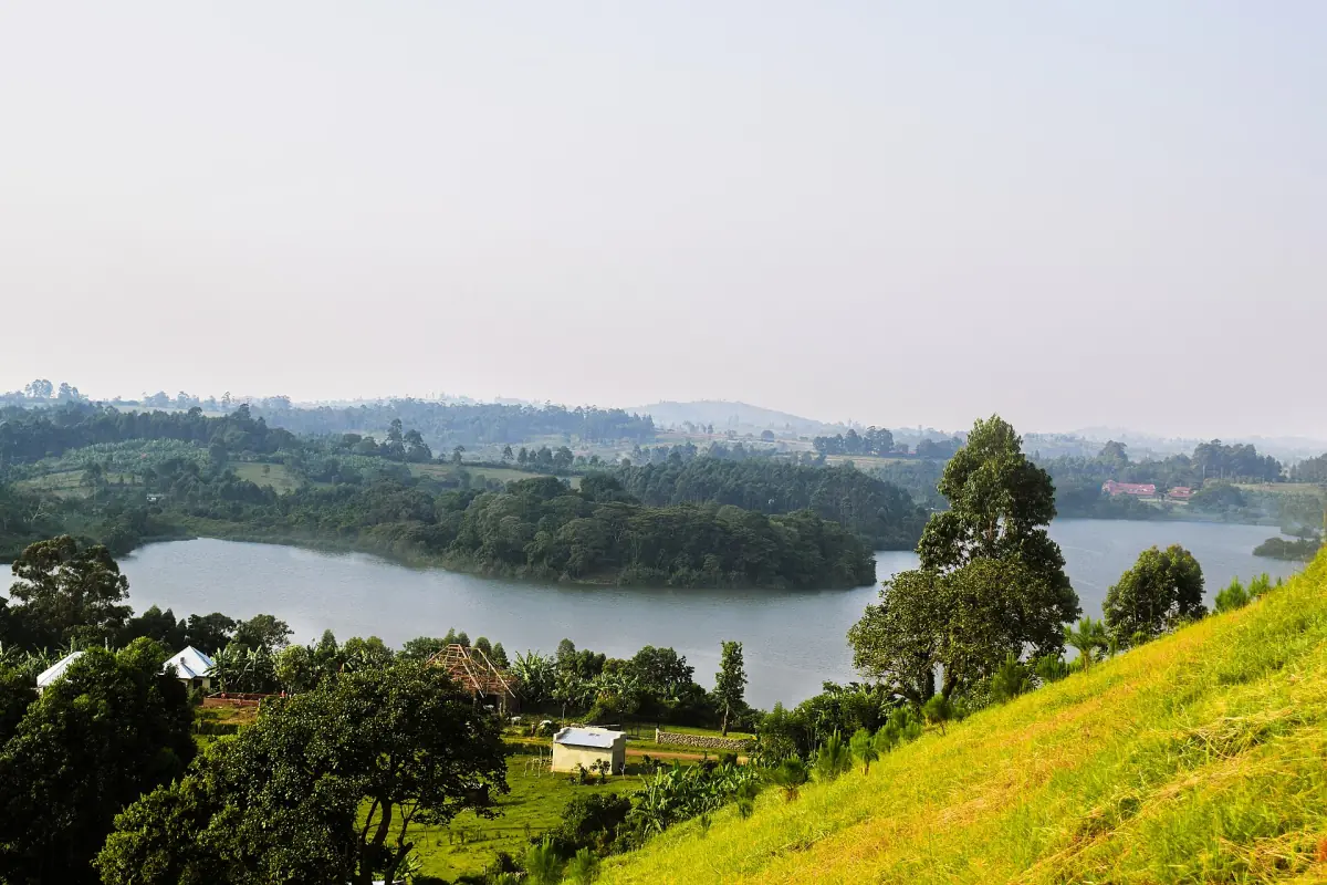 Crater lake with wooded shore seen from the slopes of Nyakasura hills