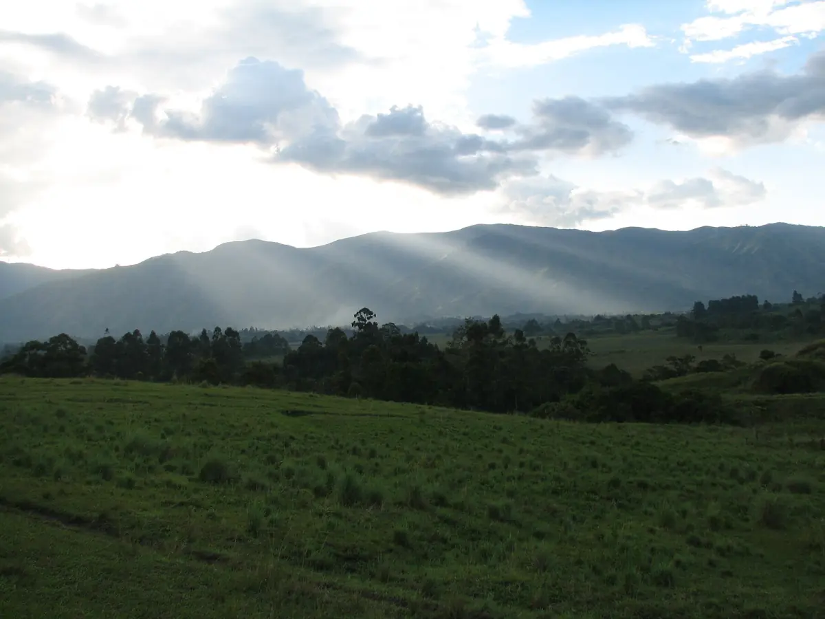 Sunlight breaking over the Rwenzori foothills seen from crater lake country